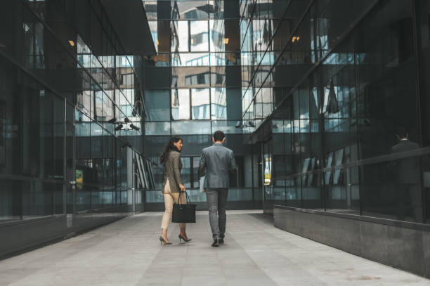 istock Business Colleagues Walking in Modern Office Corridor 2184417556
