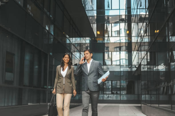 istock Business Colleagues Walking and Talking in Urban Office Complex 2184417561