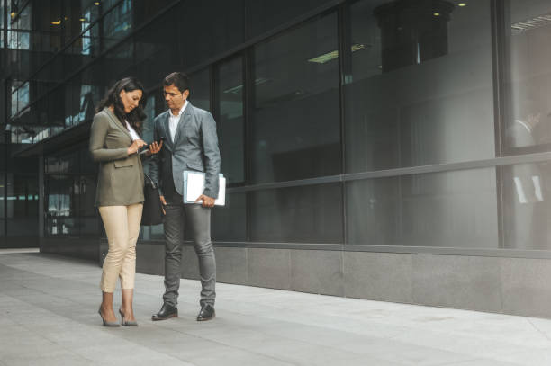 istock Business Colleagues Discussing Outside Modern Office 2184417566