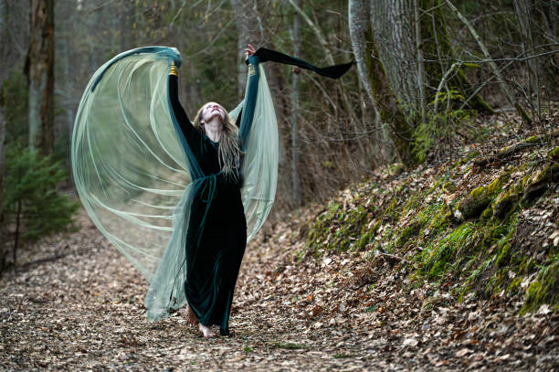 istock Woman dancing with veil in forest path. Shallow depth of feld 2184417804