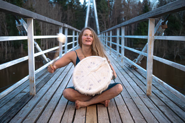 Woman playing drum on bridge. Shallow depth of feld
