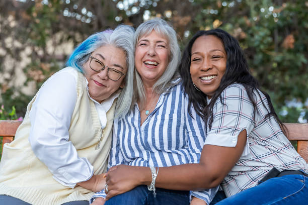 istock Three older best friends laughing on a bench 2184423782