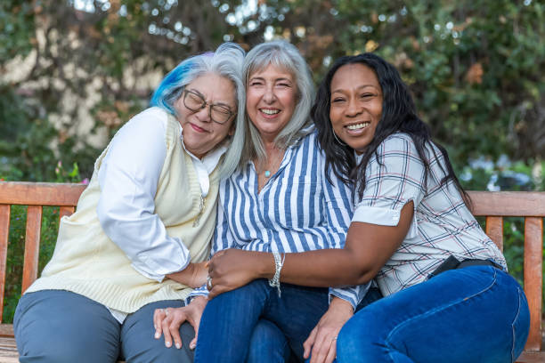 istock Three older best friends laughing on a bench 2184423843