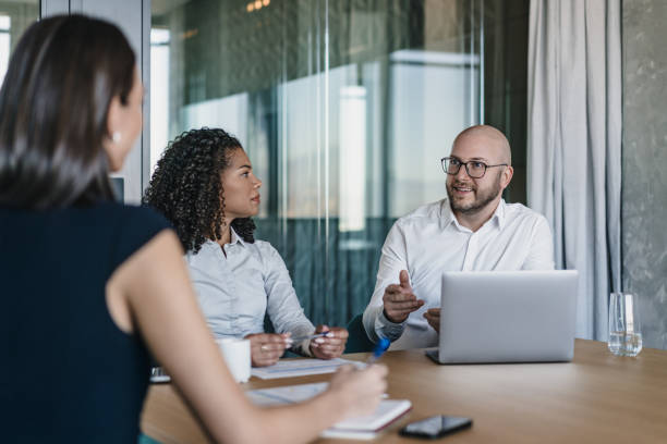 istock Group of business persons having a discussion 2184424325