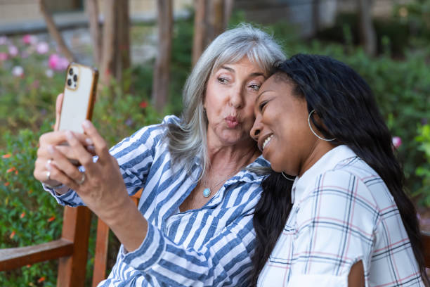 istock Two older women taking a selfie on a bench 2184424707