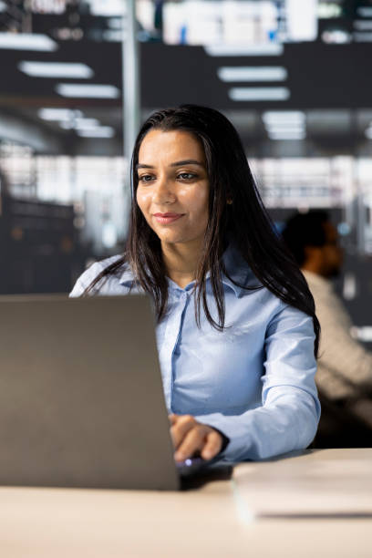 istock Professional business developer engages in project management at her desk 2184424860