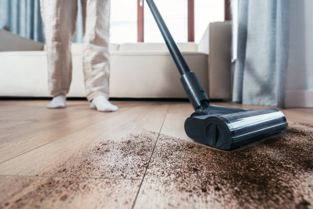istock Vacuuming dust from hardwood floors at cozy home 2184428507