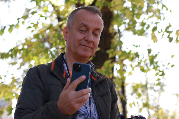 istock Mature man in adventure in nature using phone 2184428677