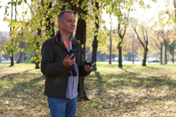 istock Mature man in adventure in nature using phone 2184428895