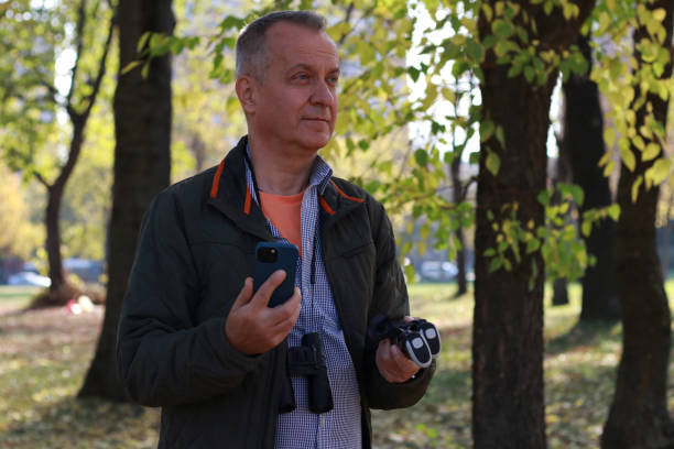 istock Mature man in adventure in nature using phone 2184428960