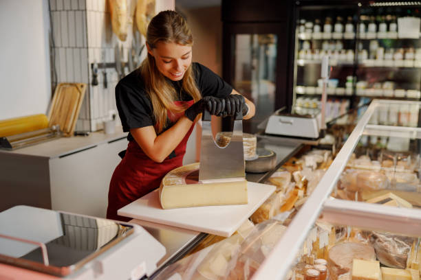 istock A Cheese Expert is Skillfully Slicing various cheeses in a Gourmet Shop for customers enjoyment 2184429497