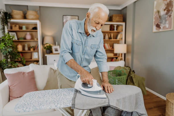 istock Ironing clothes in living room 2184429663