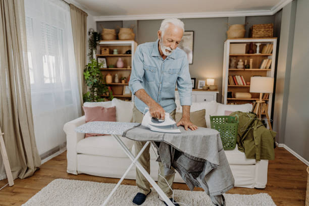istock Ironing clothes in living room 2184429666