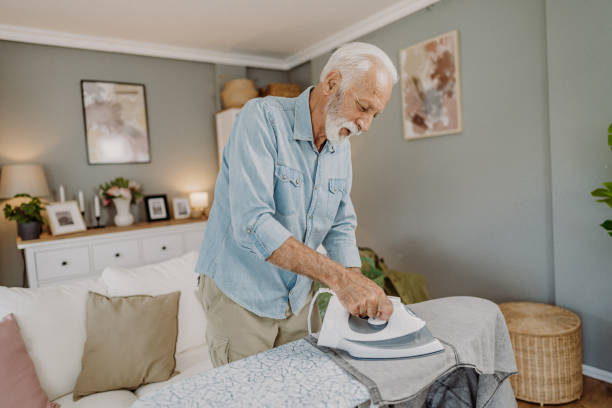 istock Ironing clothes in living room 2184429682