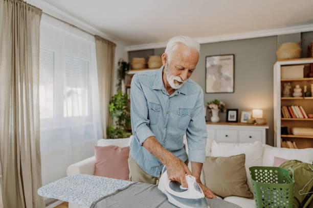 istock Ironing clothes in living room 2184429684