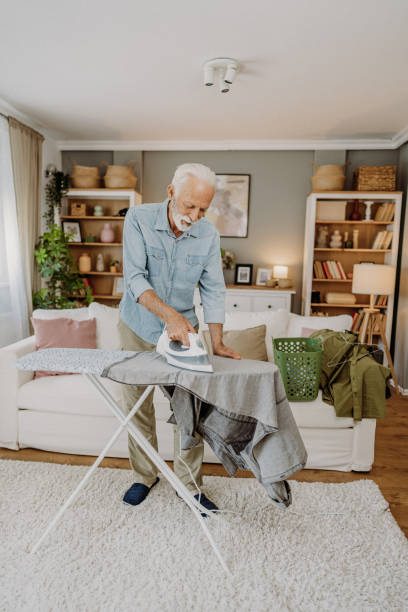 istock Ironing clothes in living room 2184429686
