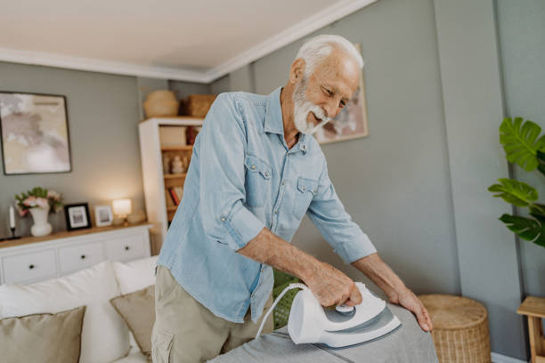 istock Ironing clothes in living room 2184429687