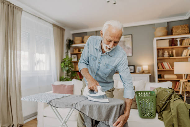 istock Ironing clothes in living room 2184429706