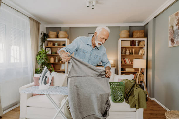 istock Ironing clothes in living room 2184429715