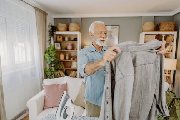 istock Ironing clothes in living room 2184429719