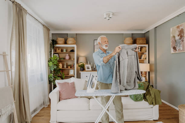 istock Ironing clothes in living room 2184429727