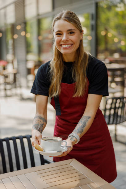 istock A Cheerful Waitress Serving Hot Coffee Outdoors in a Beautiful Environment with Sunshine 2184430157