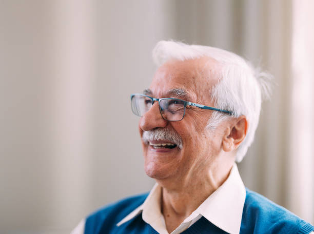 istock Senior Man Smiling Joyfully At Home With Glasses On 2184430169