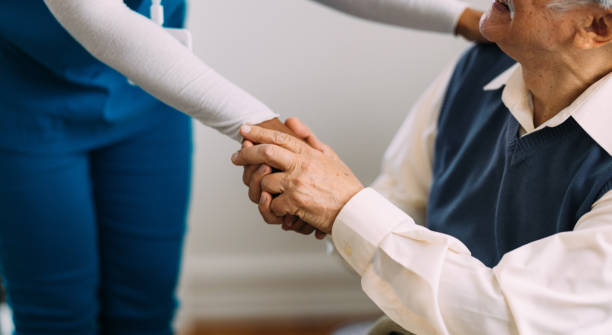 istock Caring Nurse Comforting Elderly Man With Compassionate Support 2184430182