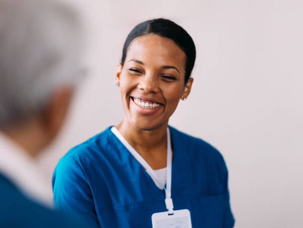 istock Smiling Nurse Engaging in Conversation with a Patient 2184430187