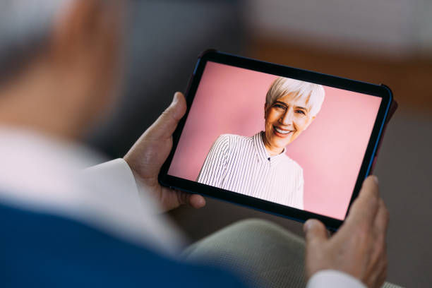 istock Elderly Person Engaging in Video Call on Digital Tablet 2184430254