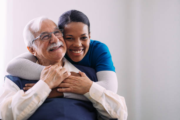 istock Caring Nurse Embracing Happy Elderly Man in Warm Moment 2184430260