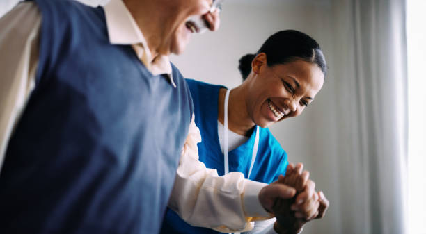 Friendly Caregiver Assisting Elderly Man with Genuine Smile