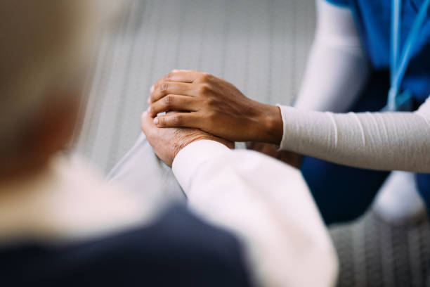 Compassionate Caregiver Comforting Elderly Patient with Gentle Touch