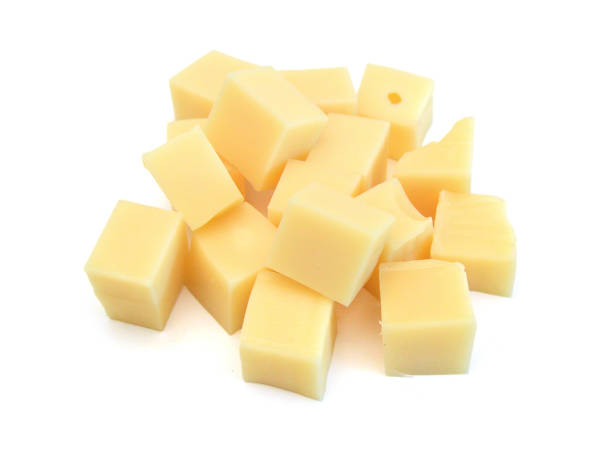 istock Cubes of cheddar cheese isolated on white 2184432469