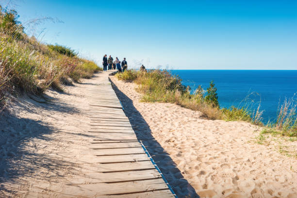 People hike on the Empire Bluff Trail in Sleeping Bear Dunes National Lakeshore in Michigan, USA on a sunny day.
