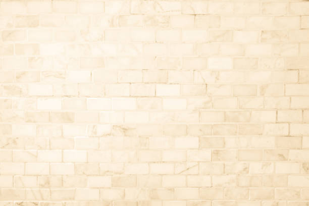 Cream ceramic brick wall and floor tiles mosaic texture background in bathroom old. Design pattern stone geometric with grid wallpaper texture decoration room. Simple seamless abstract surface clean.