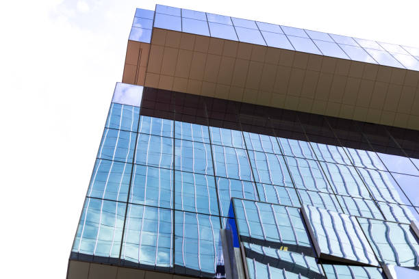 istock Low angle view of modern office building with reflection, skyscraper, background with copy space 2184437912