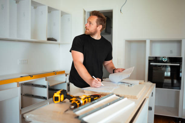 istock Focused Caucasian Man Building Kitchen Cabinets 2184439031