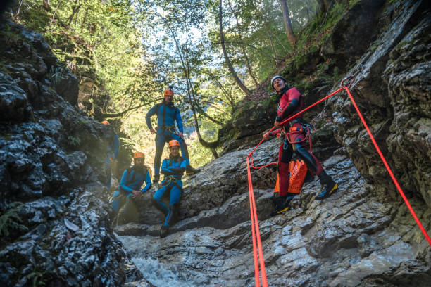istock Diverse People Descending Waterfall with Rappel Ropes in Canyoning Adventure 2184439999