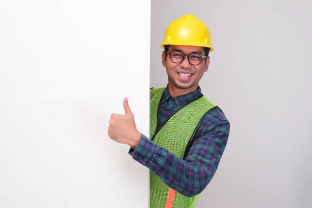 istock An civil engineer peeking out behind wall give thumbs up with happy expression 2184442223