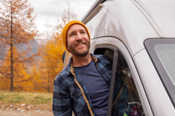 istock Man Enjoying the Outdoors from Camper Van Window 2184442744