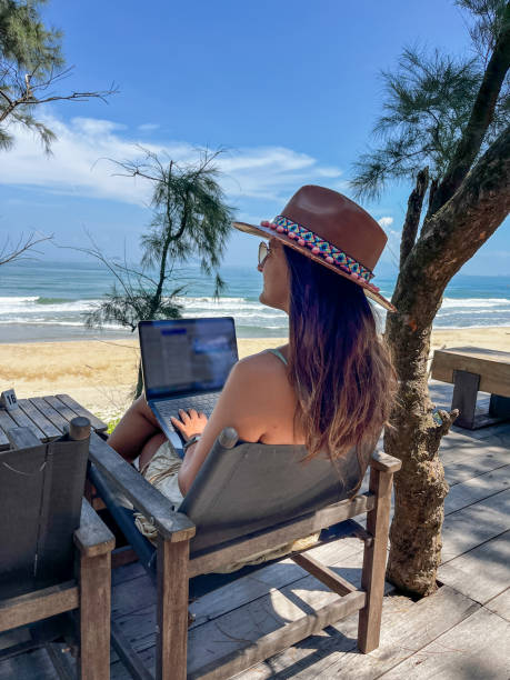 istock Woman Working Remotely with a Beach View 2184447768
