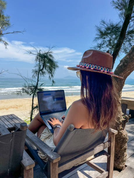 istock Woman Working Remotely with a Beach View 2184447772