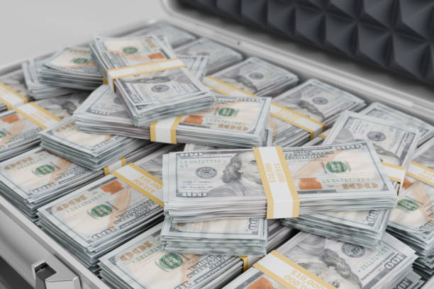 istock metal suitcase overflowing with stacks of crisp, new hundred-dollar bills, representing financial prosperity and wealth. It's a visual metaphor for success, abundance 2184450082
