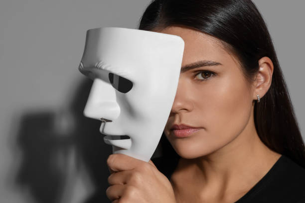 istock Multiple personality concept. Woman with mask on grey background 2184451087