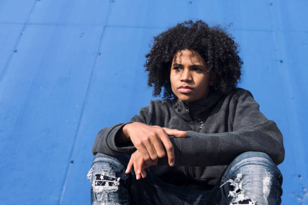thoughtful curly haired teenager in informal wear