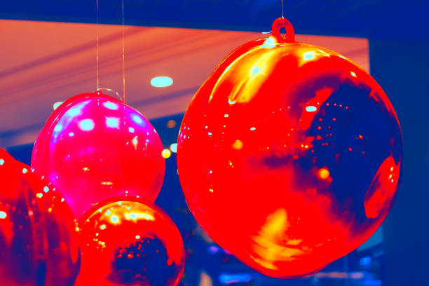 Christmas vibrant red balloons suspended from a ceiling, creating a festive and cheerful atmosphere