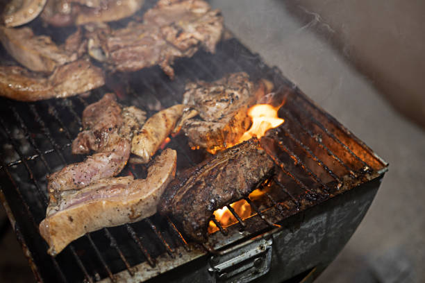 istock The pork is roasted on the grill as it smokes. 2184457023