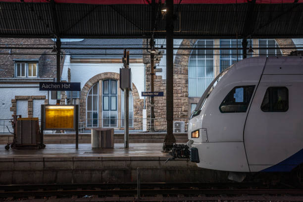 istock sign Aachen Hbf , meaning Aachen Hauptbahnhof (Aachen main train station in german laguage) in front of a EMU electric train ready for departure. 2184457080