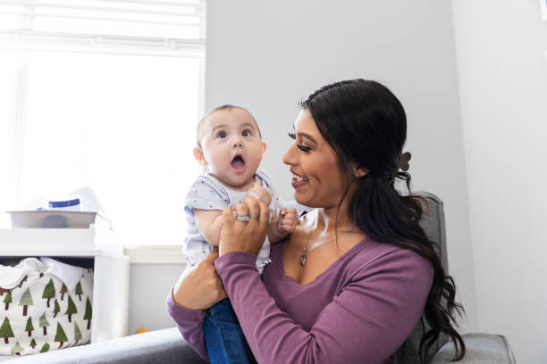 istock Happy baby held by his mom in the nursery 2184457335